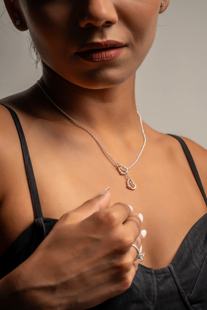 
                  
                    Modern lariat necklace featuring two hearts, crafted by Klarity
                  
                