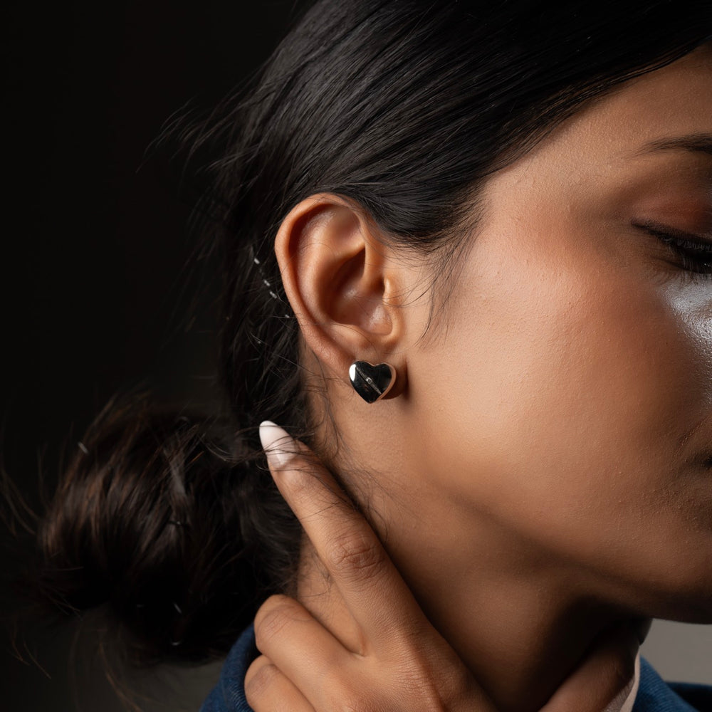 Sterling silver heart-shaped studs with rhodium plating by Klarity