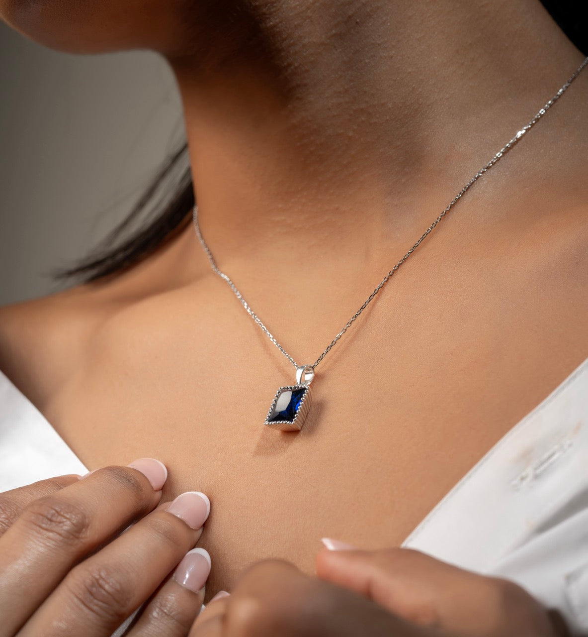 Bold rectangular blue stone pendant by Klarity with silver-tone detailing
