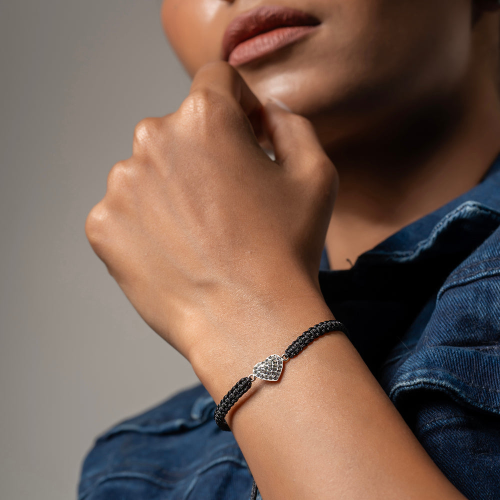 
                  
                    Minimal black cord bracelet featuring a CZ-studded heart charm


                  
                