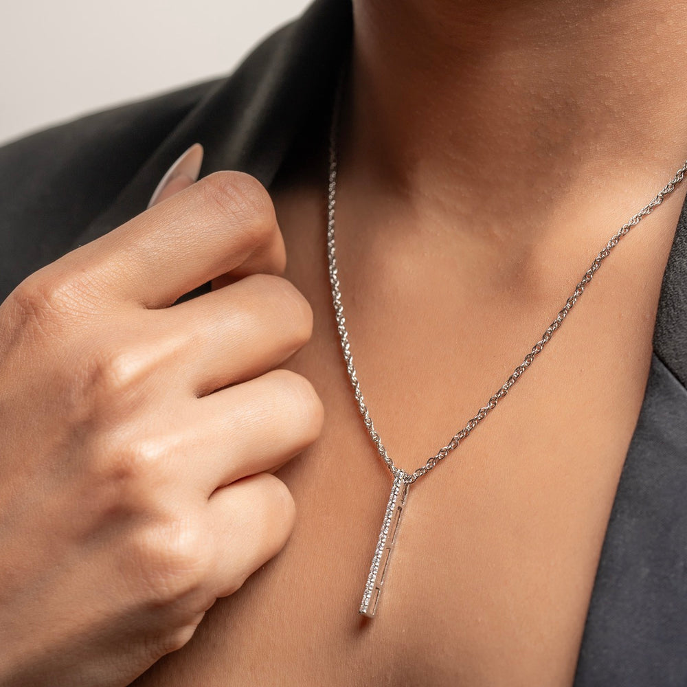 Fashion editor styling Klarity’s bar pendant with chain.