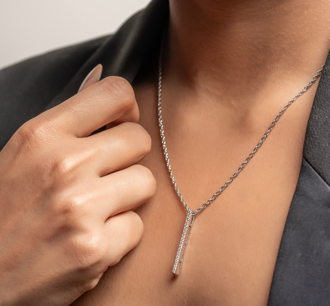 Fashion editor styling Klarity’s bar pendant with chain.