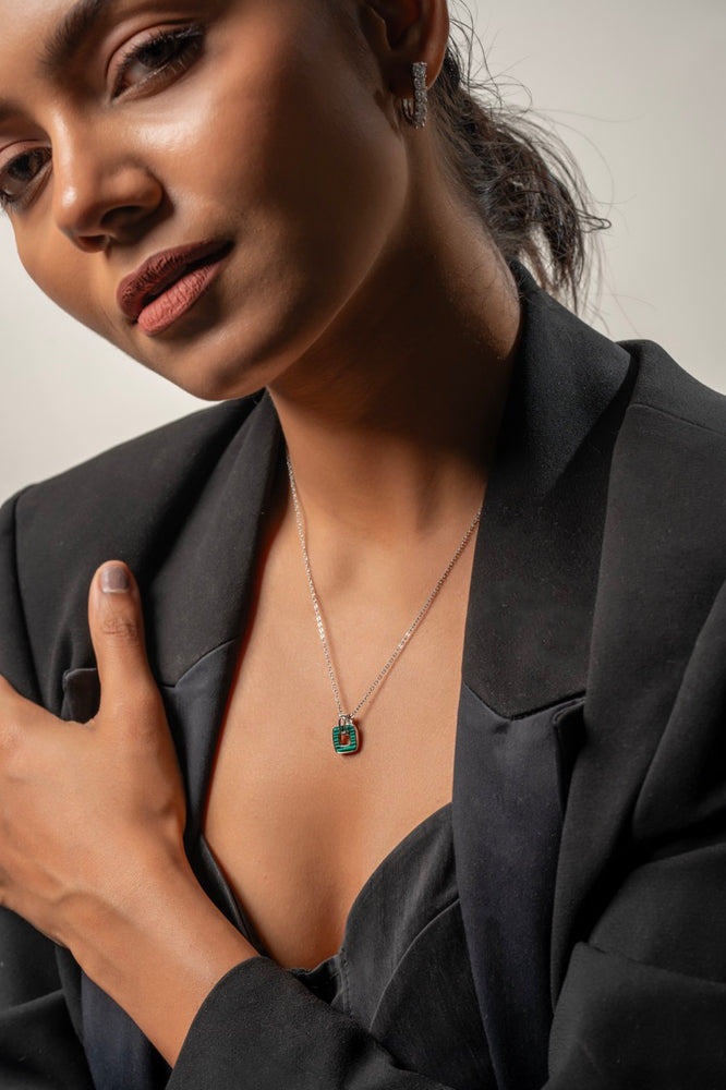 
                  
                    Close-up of precision CZ accents on Klarity’s square pendant edges
                  
                