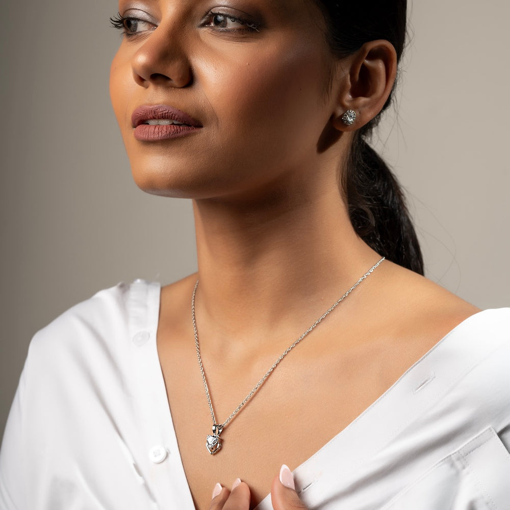 
                  
                    Klarity’s delicate open heart design cradling CZ stone.
                  
                