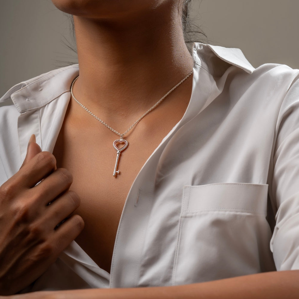 Woman wearing heart key pendant necklace with denim for everyday style