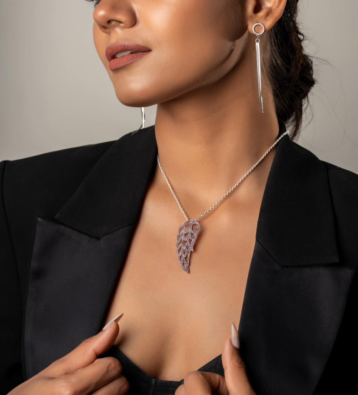 Elegant angel wing necklace by Klarity featuring red-toned accents