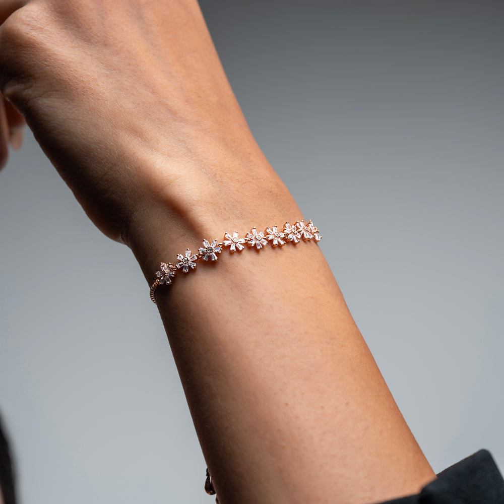 
                  
                    Rose gold-plated sterling silver bracelet with intricate flower design
                  
                