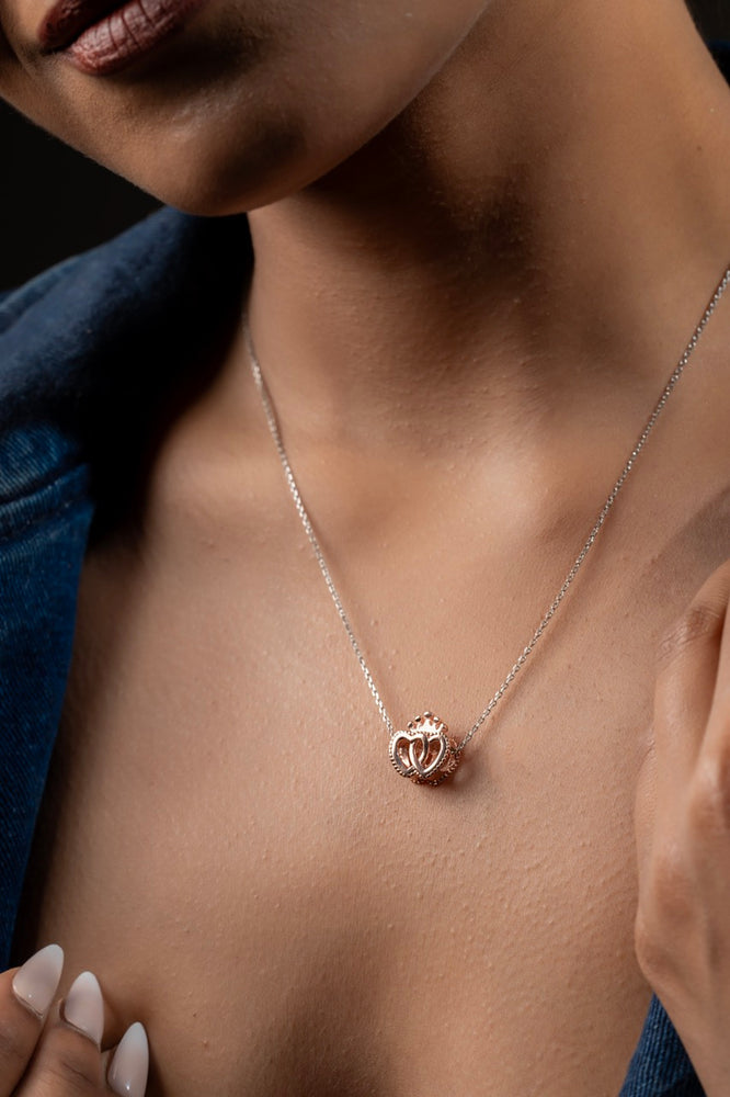 Rose gold pendant by Klarity featuring intertwined hearts with a crown accent
