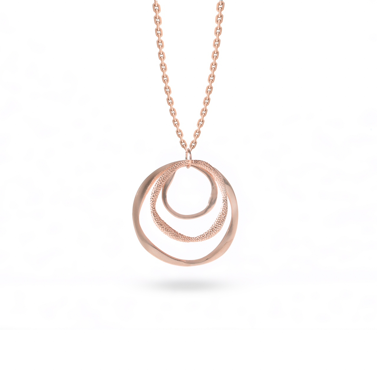 Klarity’s rose gold plated layered circle pendant showing polished/matte contrast