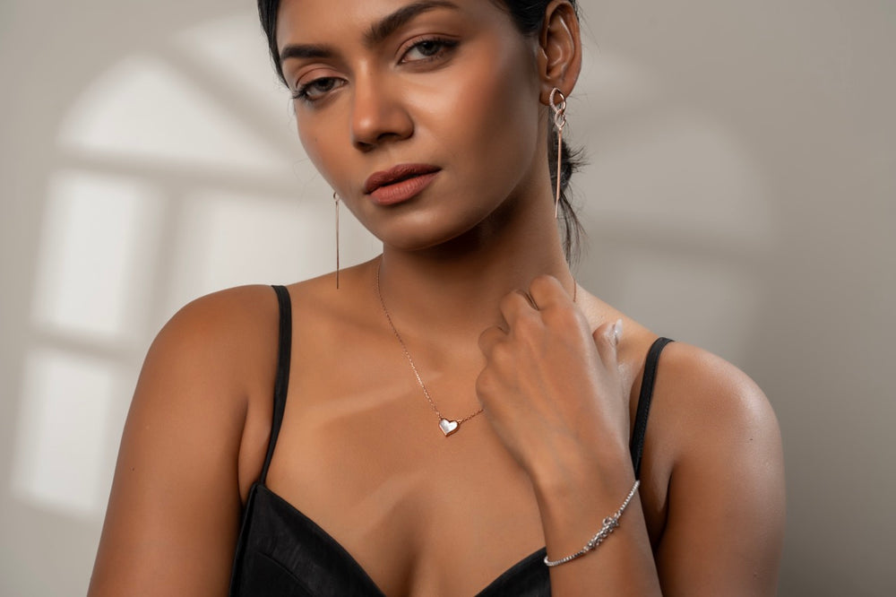 
                  
                    Rose gold pearl heart pendant layered with delicate chains for boho style
                  
                