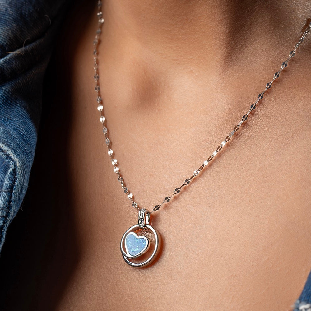Styling Klarity's blue opal heart necklace with a white linen dress for brunch