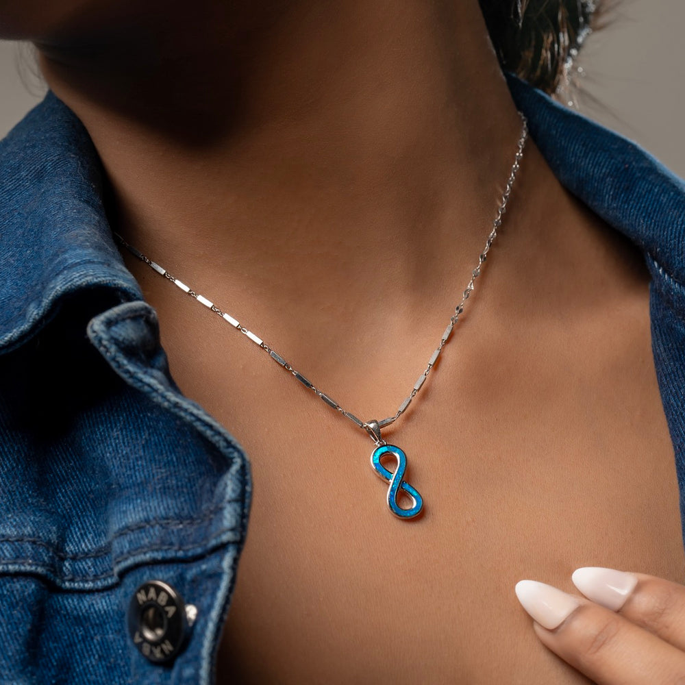 Styling Klarity's blue opal infinity necklace with denim and lace for concert outfits