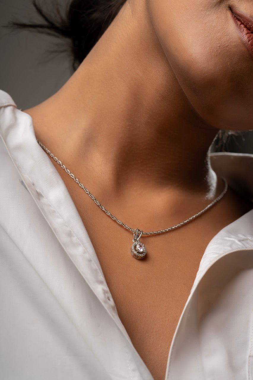 Woman wearing Klarity’s pink halo pendant for a romantic evening