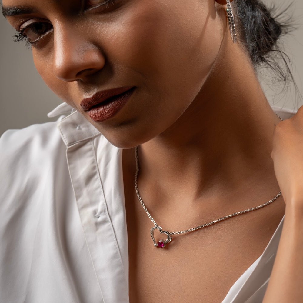 
                  
                    Close-up of vibrant raspberry accent on CZ-studded heart pendant
                  
                