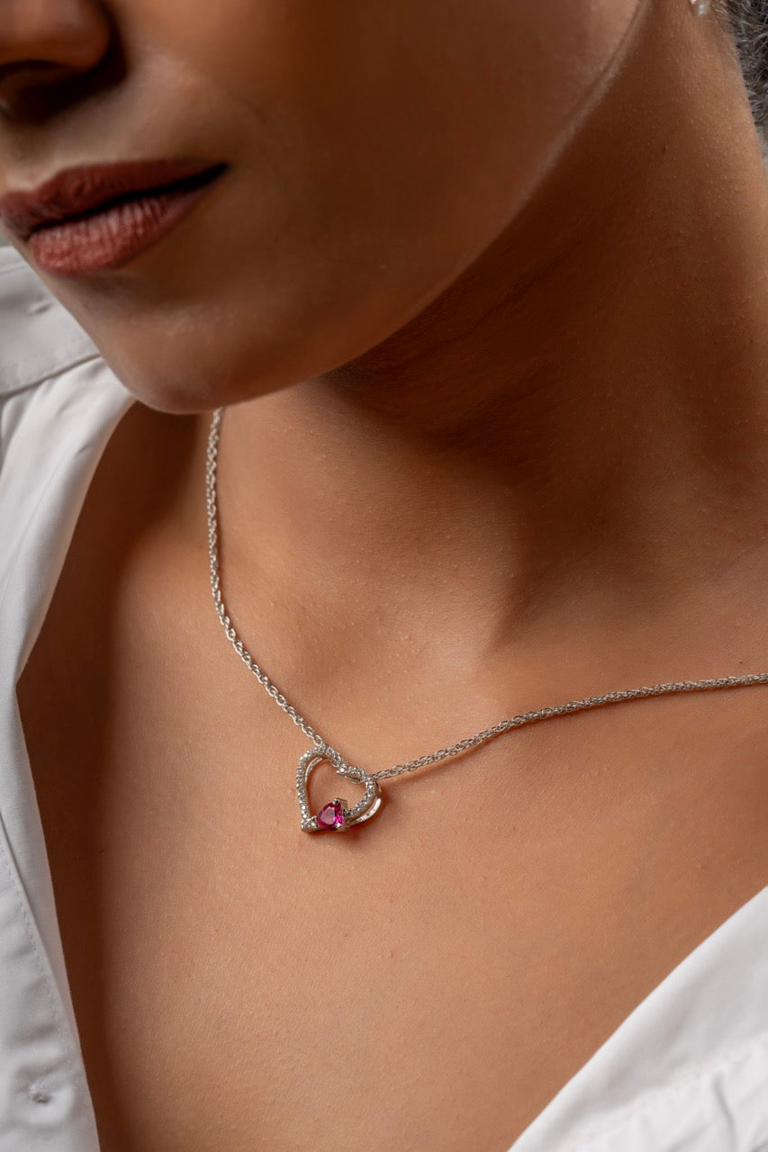 Woman wearing raspberry heart pendant for a party - Klarity jewelry