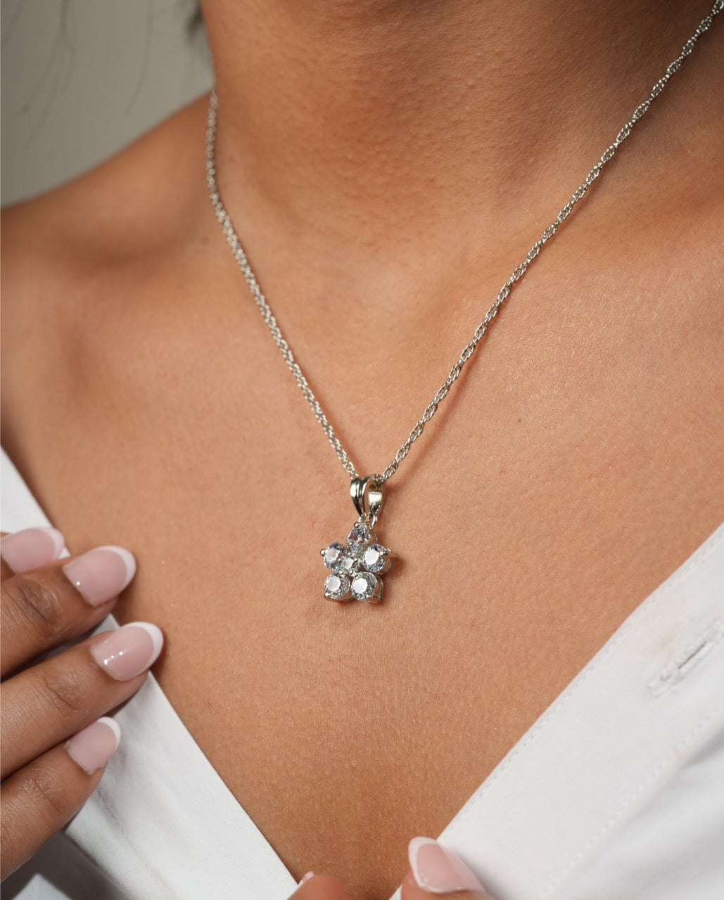 Woman wearing Klarity’s snowflake pendant for Christmas party