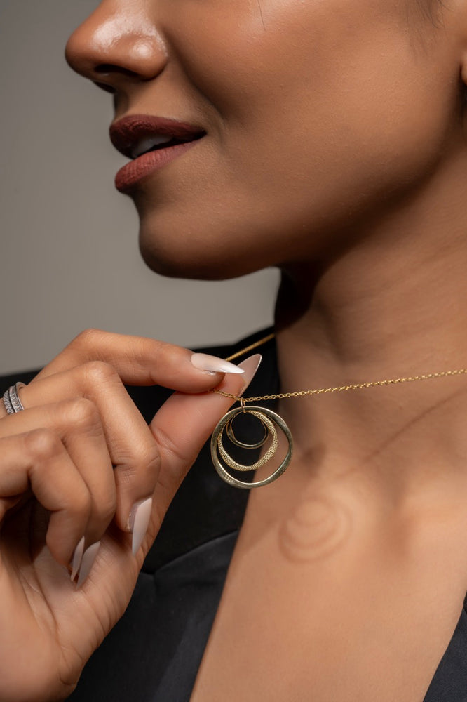 
                  
                    Klarity’s layered circle pendant with neutral tones
                  
                
