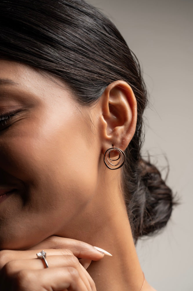 
                  
                    Elegant layered circle earrings with intricate textures and minimalist design – Klarity
                  
                
