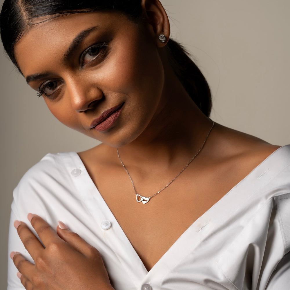 
                  
                    Crafted with love and bond, our Two Hearts pendant Necklace in 925 Silver. Shop now.
                  
                
