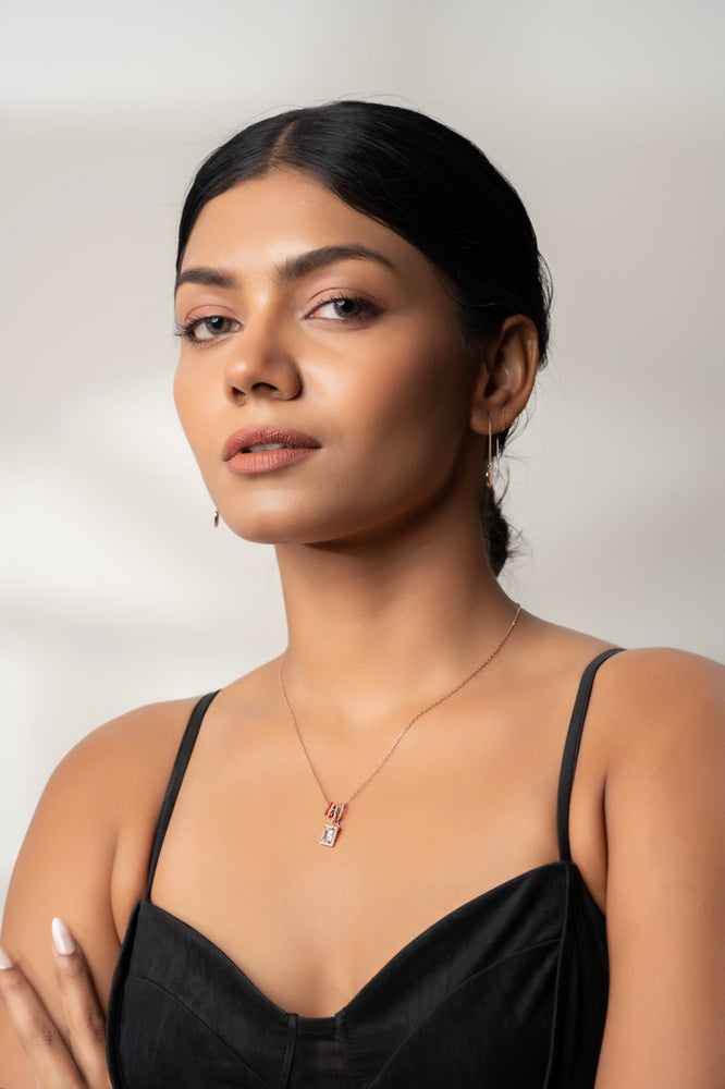 
                  
                    Fashion editor styling Klarity’s multi-charm pendant with layered chains
                  
                