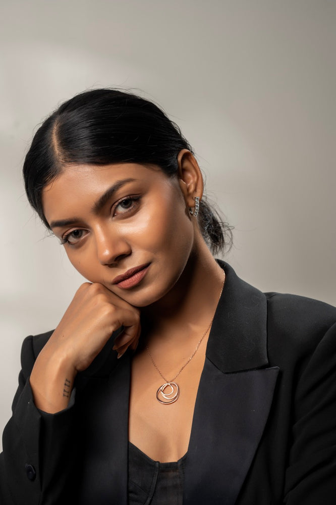 
                  
                    Fashion influencer styling Klarity’s layered circle pendant with neutral tones
                  
                